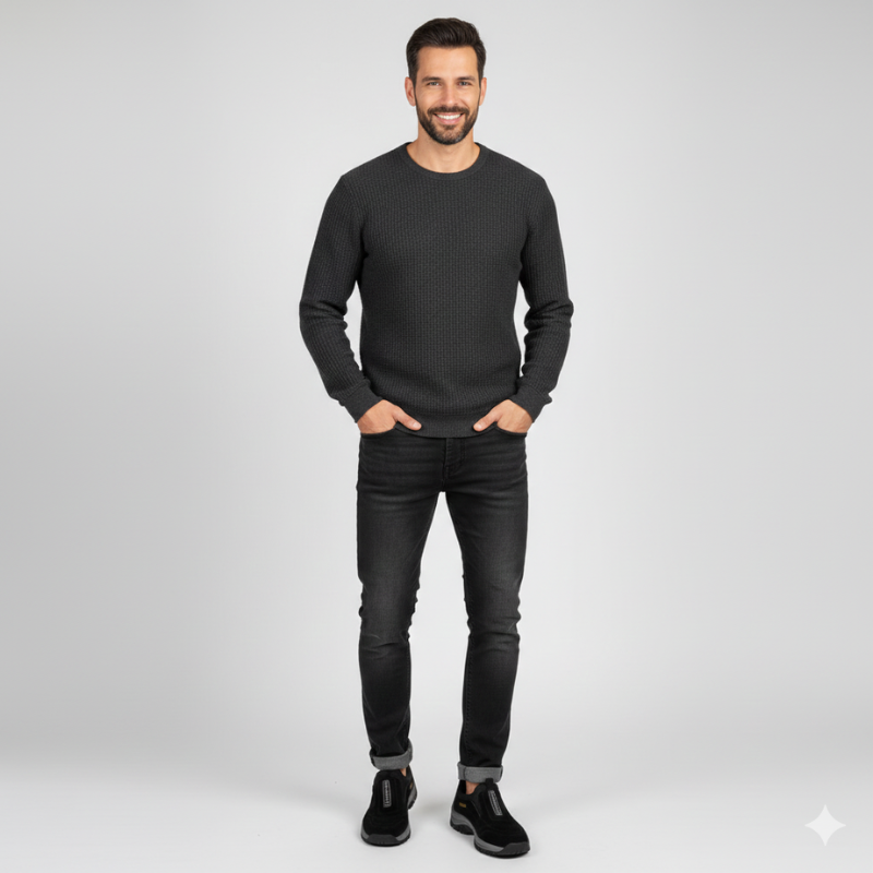 Man wearing a black sweater and jeans on a white background