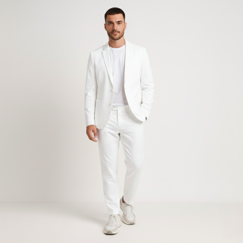 Man wearing a white suit on a plain background