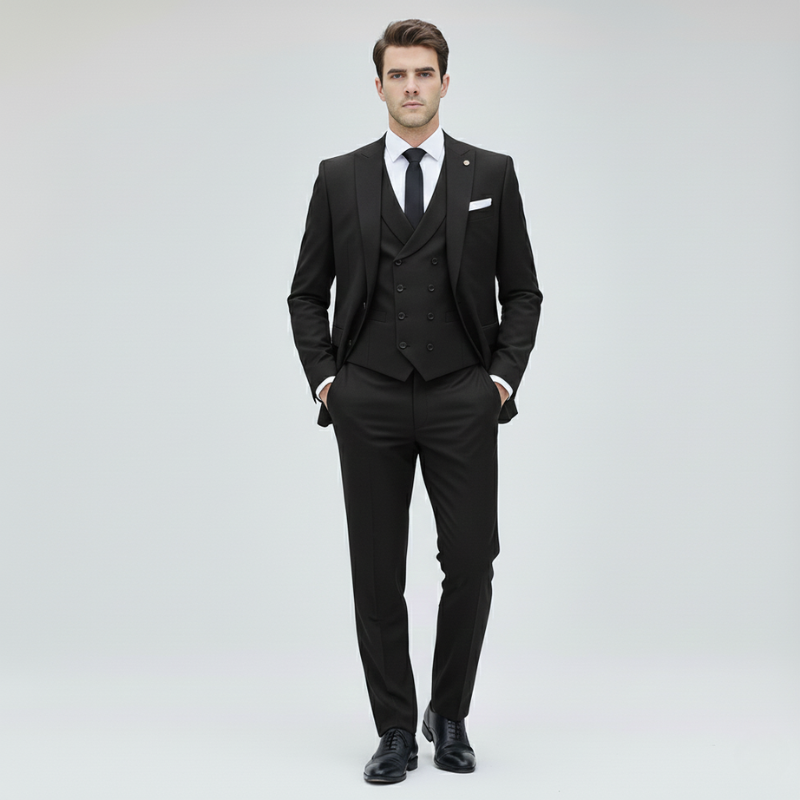 Man wearing a black three-piece suit on a light gray background