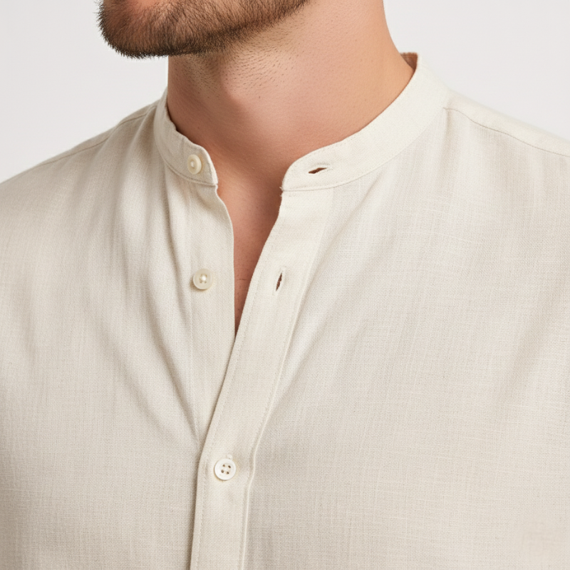 Close-up of a beige button-up shirt worn by a person on a light gray background