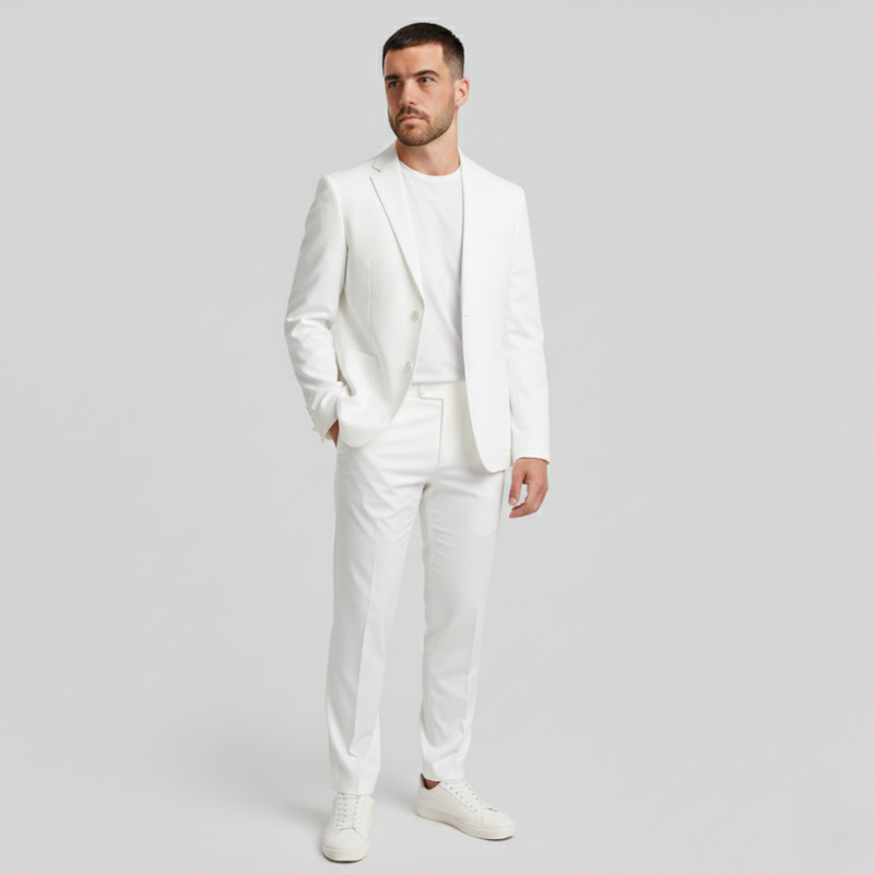 Man wearing a white suit on a plain background