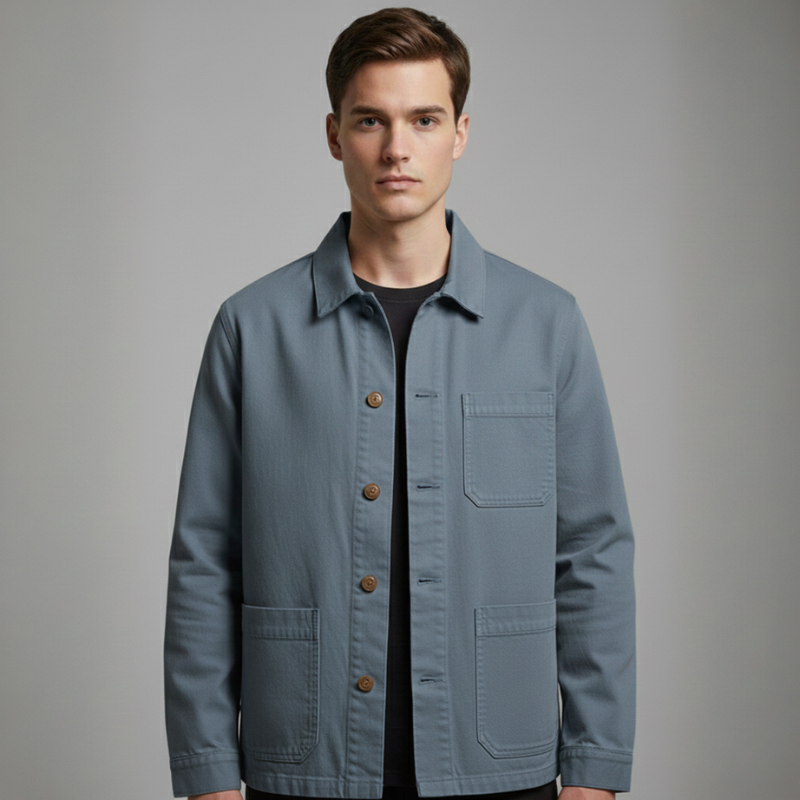 Man wearing a light blue jacket on a gray background