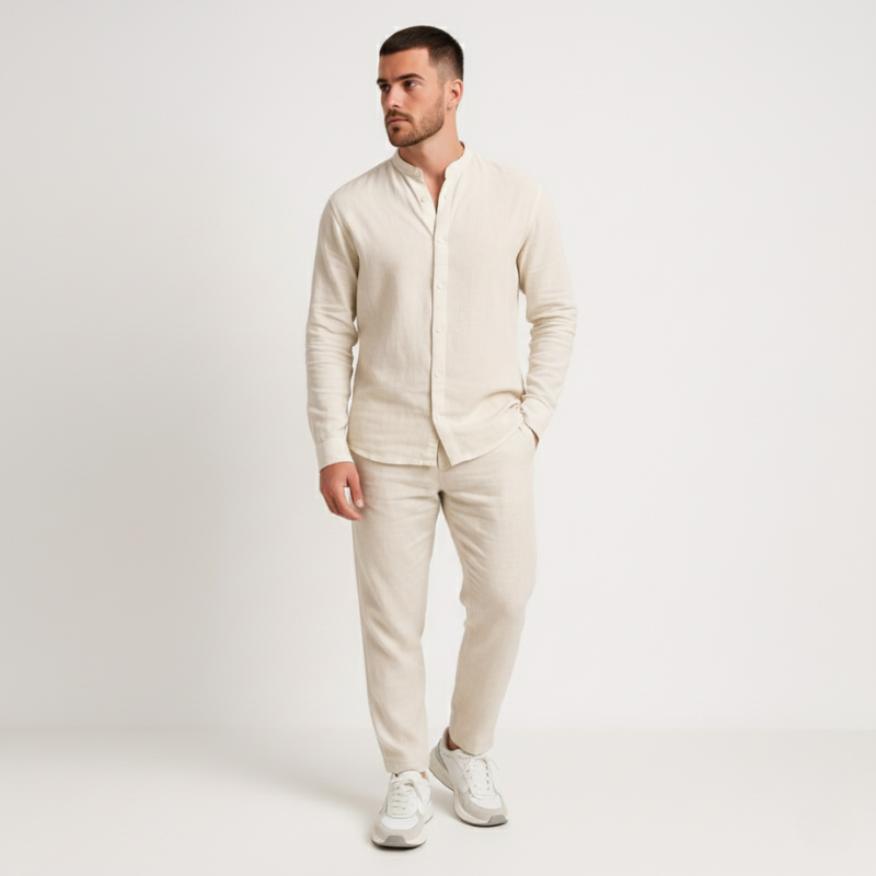 Man wearing a beige suit with white sneakers on a light gray background