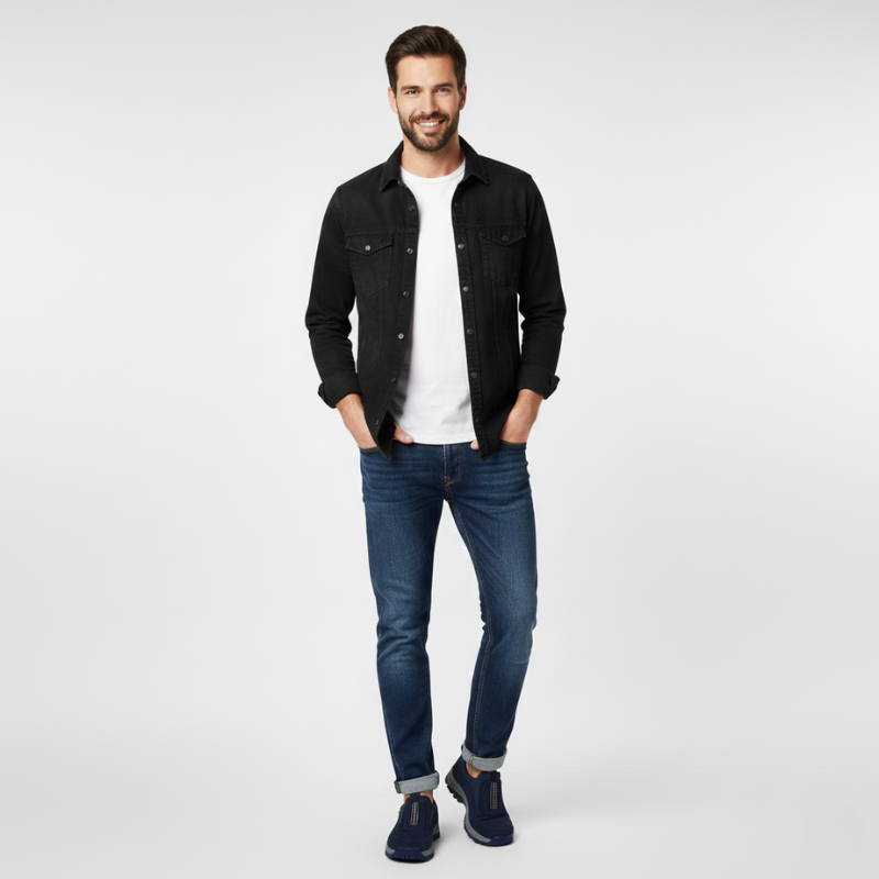 Man wearing a black denim jacket, white t-shirt, and blue jeans on a white background