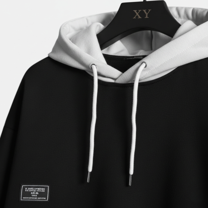 Black hoodie with white hood and drawstrings on a hanger with 'XY' branding.
