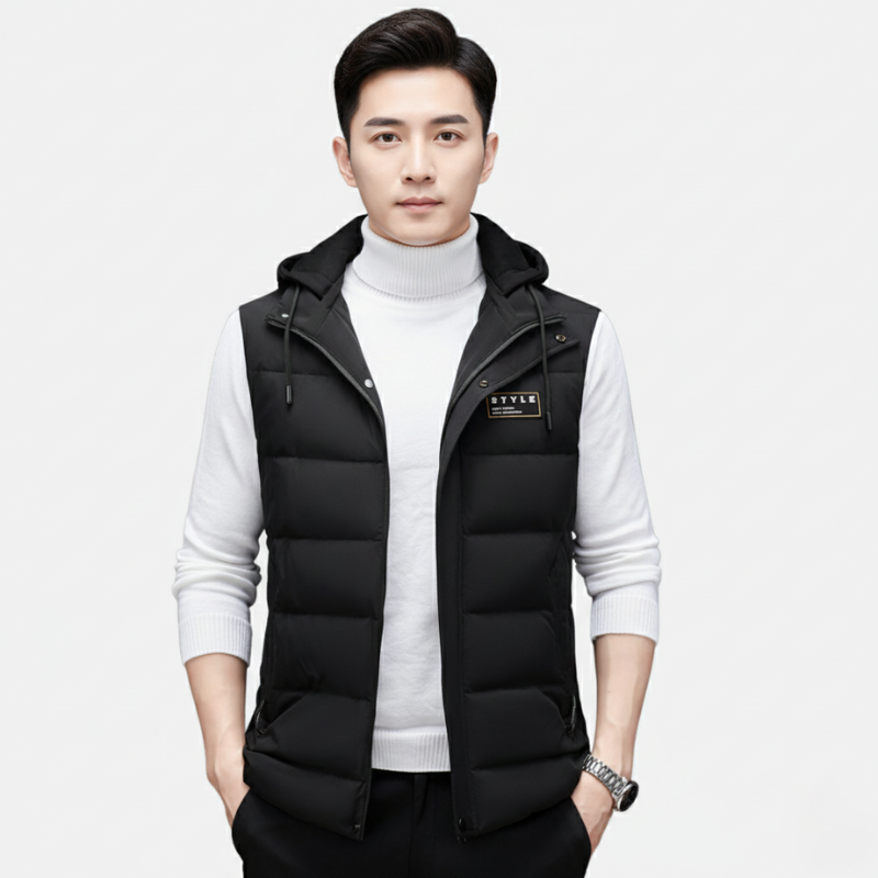 Man wearing a black puffer vest over a white turtleneck on a white background