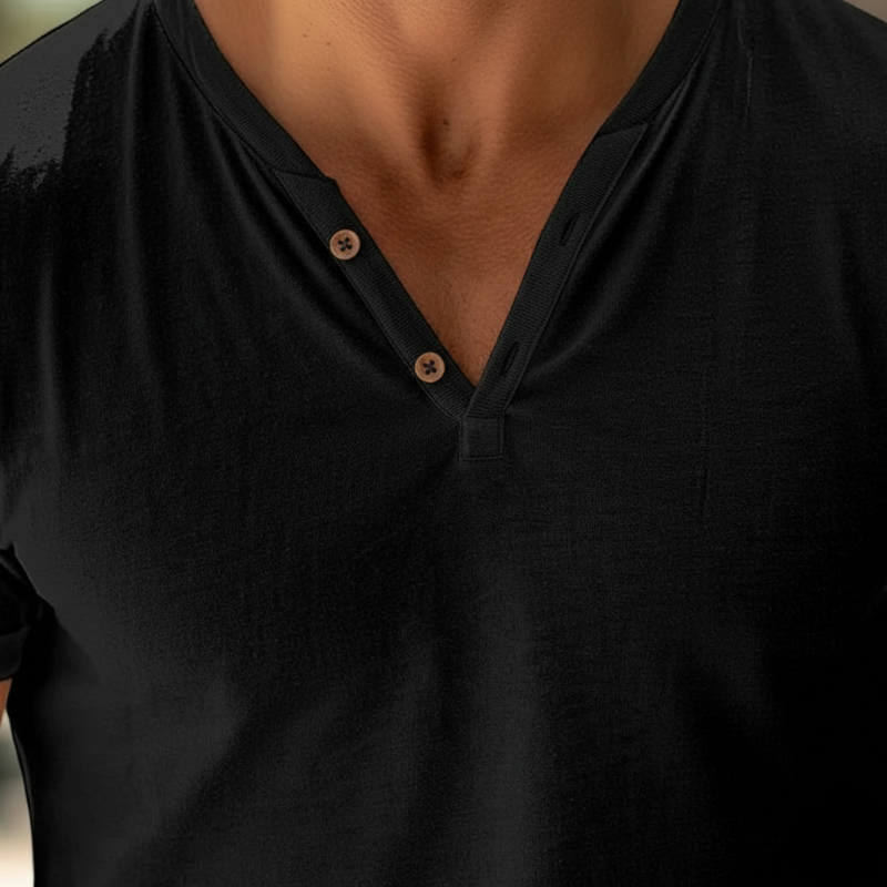 Close-up of a black shirt with buttons on a blurred background