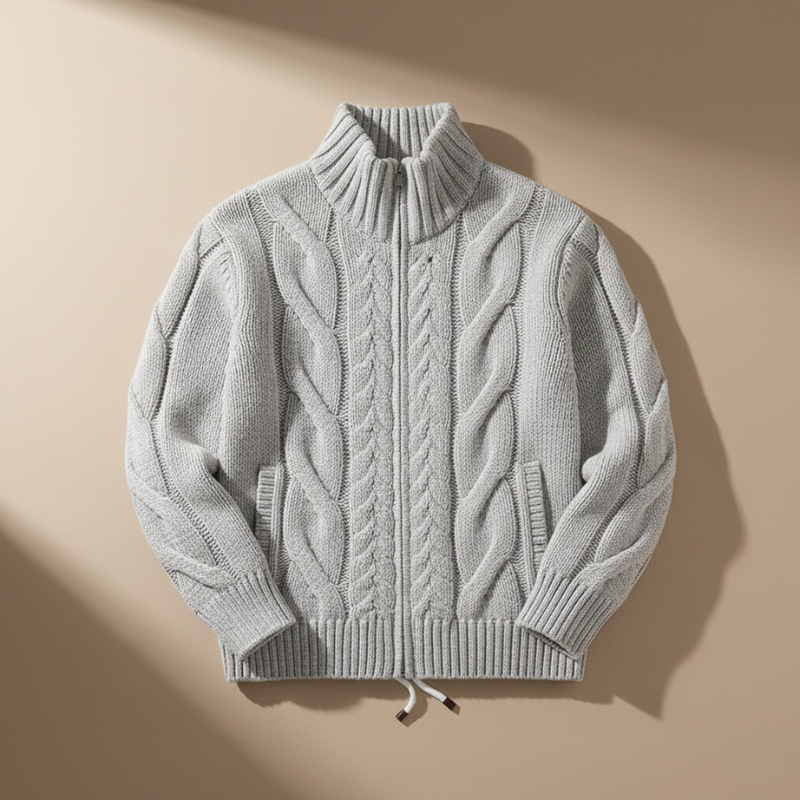 Gray cable knit sweater on a beige background