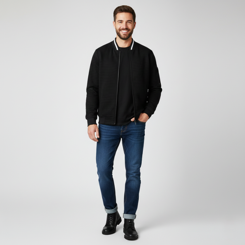 Man wearing a black jacket, blue jeans, and black shoes on a white background