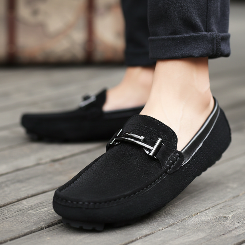 Black loafers worn on a wooden floor
