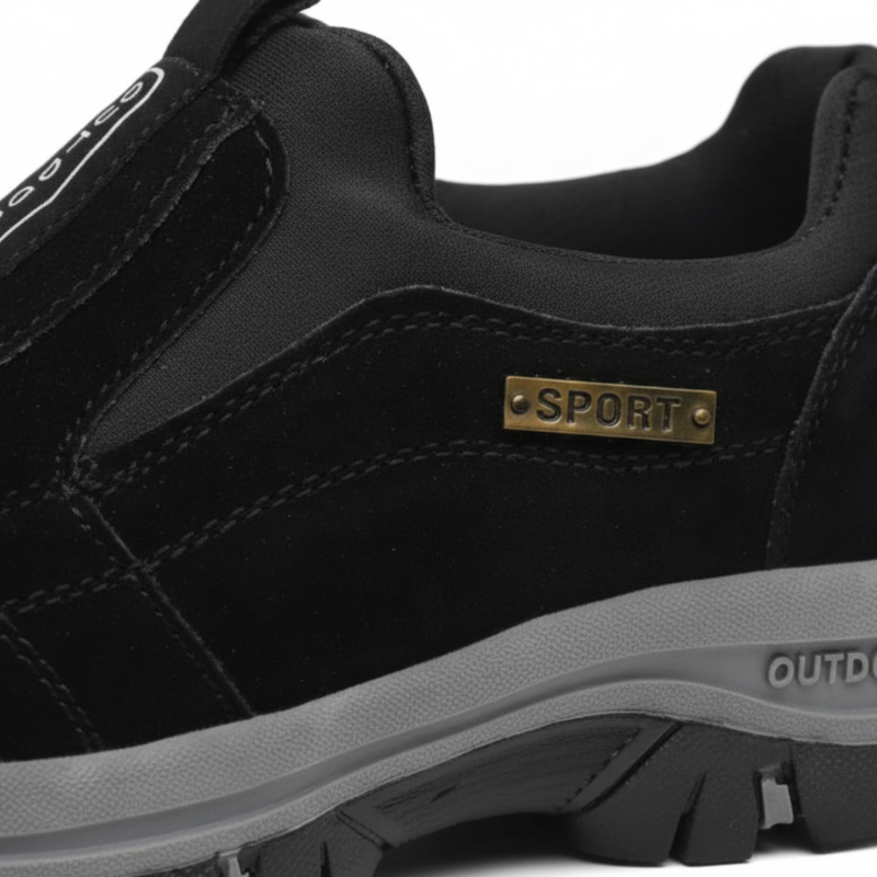 Black athletic shoe with 'Sport' label on a white background