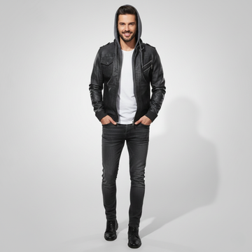 Man wearing a black leather jacket, white shirt, and black jeans on a light gray background