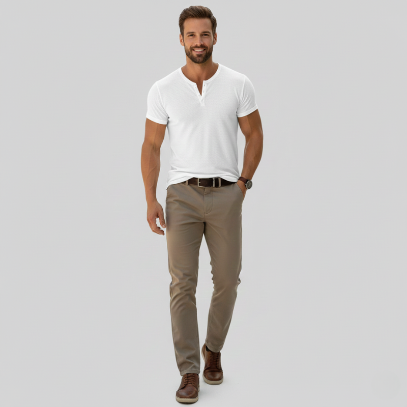 Man wearing a white shirt, beige pants, and brown shoes on a gray background