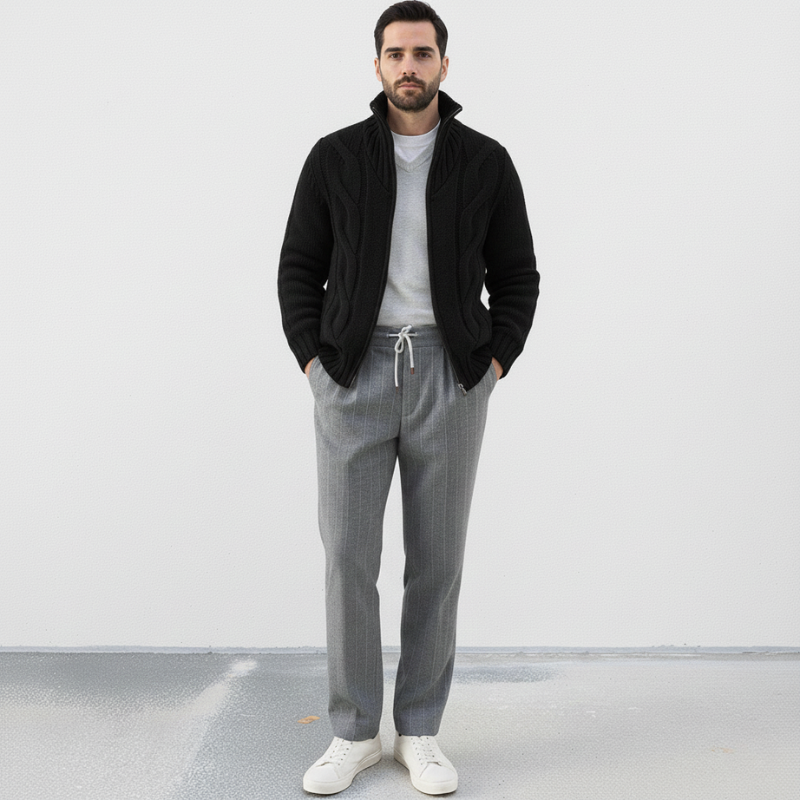 Man wearing a gray sweater and pants with a white background