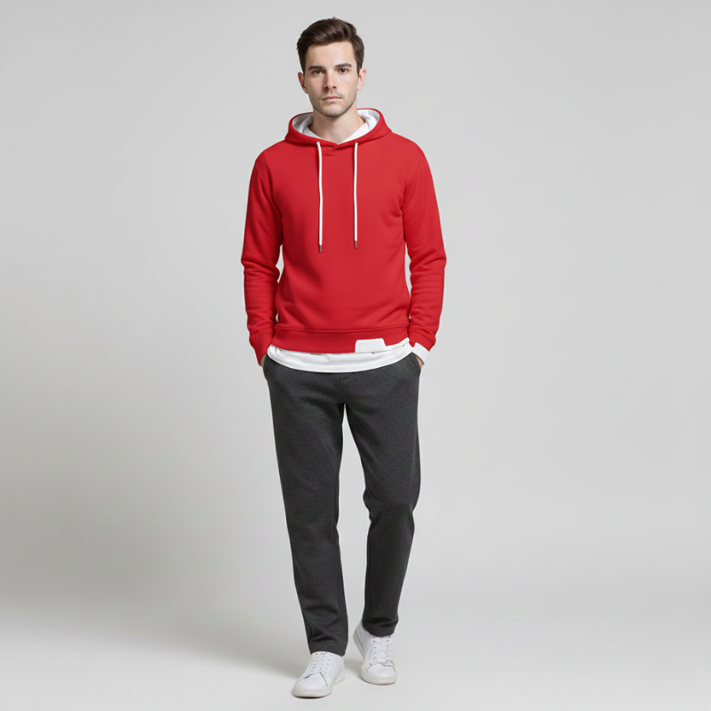 Man wearing a red hoodie, black pants, and white shoes on a light gray background