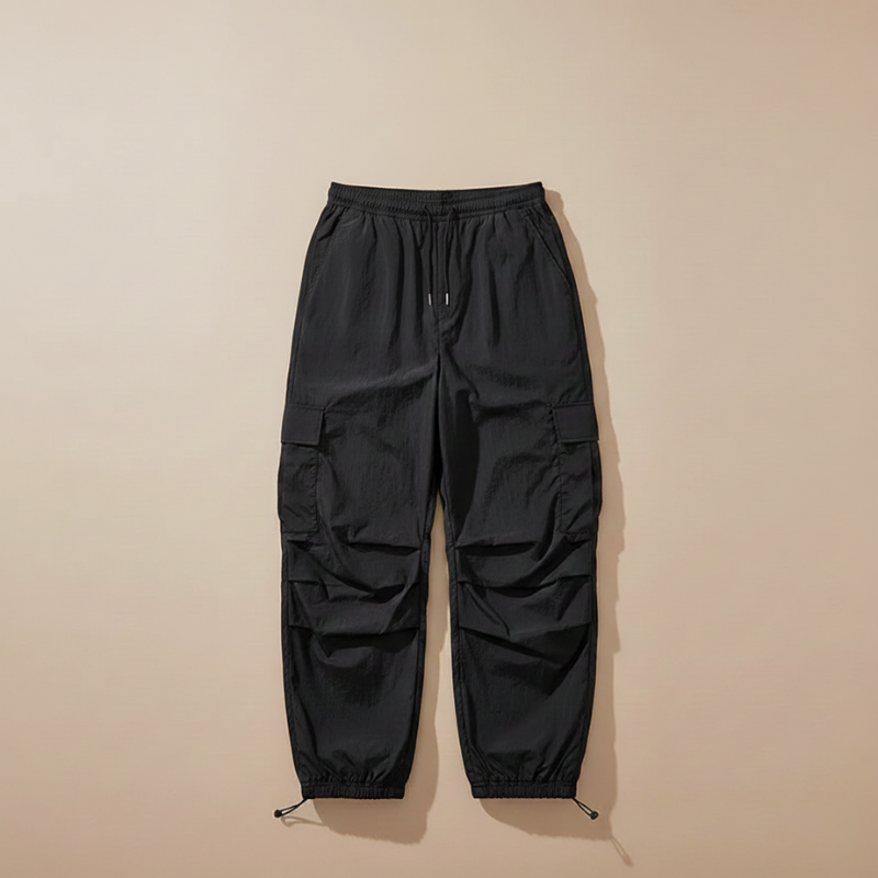Black cargo pants on a beige background
