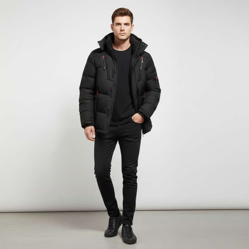 Man wearing a black puffer jacket and pants on a white background