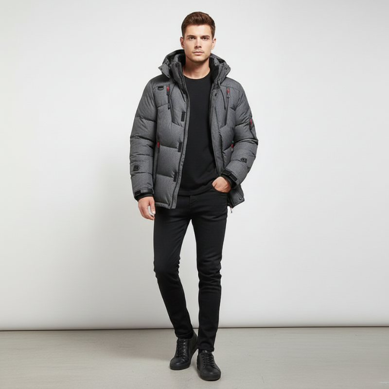 Man wearing a blue puffer jacket against a white background