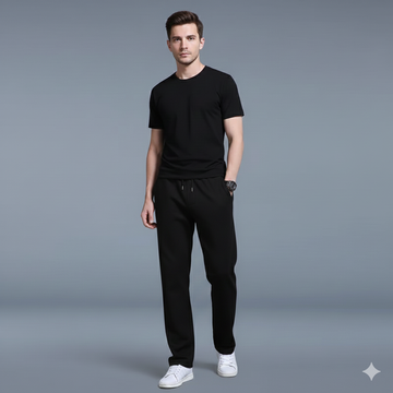 Man wearing a black t-shirt and pants on a gray background