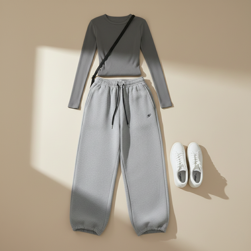Flatlay of a gray knit top and matching wide-leg pants styled with neutral accessories.