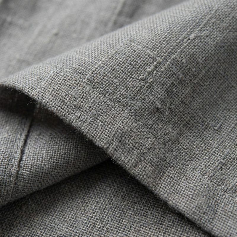 Close-up of gray fabric with visible texture and stitching