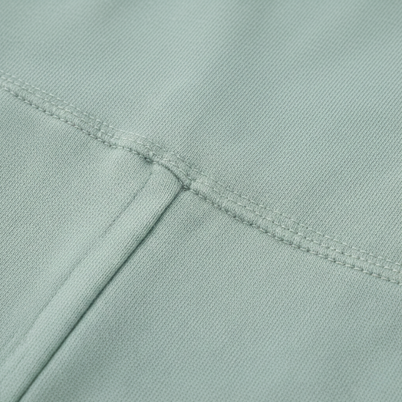 Close-up of a light green fabric with stitching detail