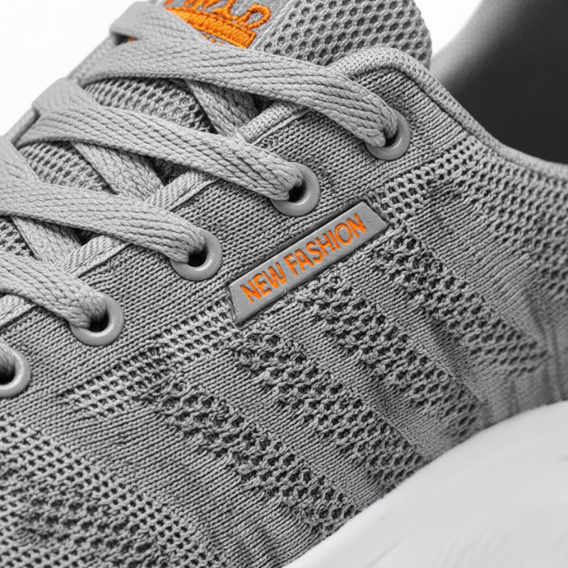 Gray sneaker with orange text on a white background