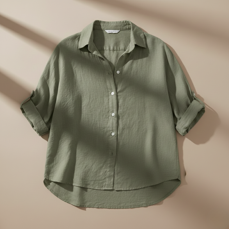 Green shirt with rolled-up sleeves on a beige background