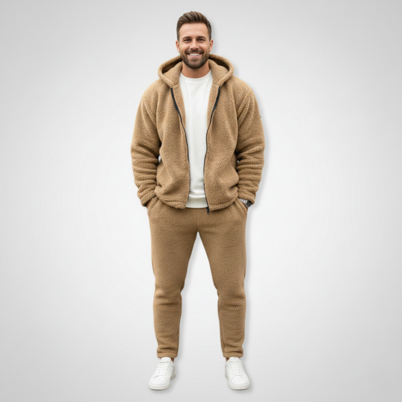 Man standing indoors wearing a beige fleece jacket styled for everyday casual wear.