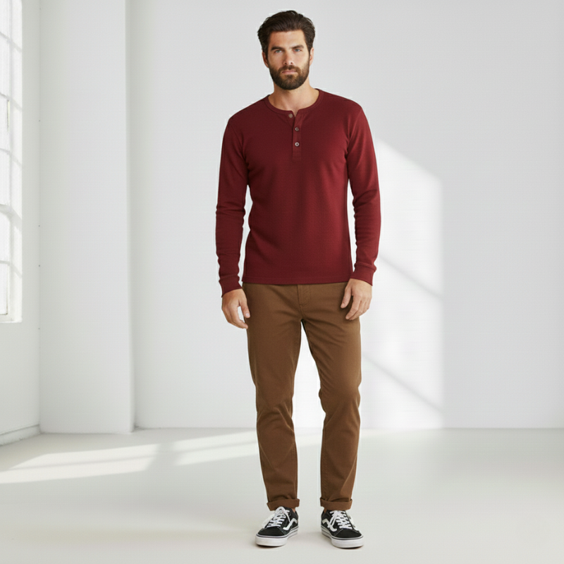 Full-body image of a man wearing a burgundy sweater styled for everyday casual wear.