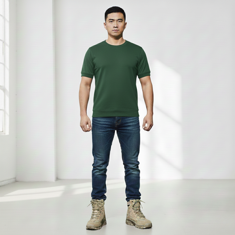 Male model standing in a green t-shirt styled with jeans for an everyday casual outfit.