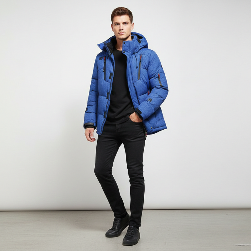 Man wearing a blue puffer jacket against a white background