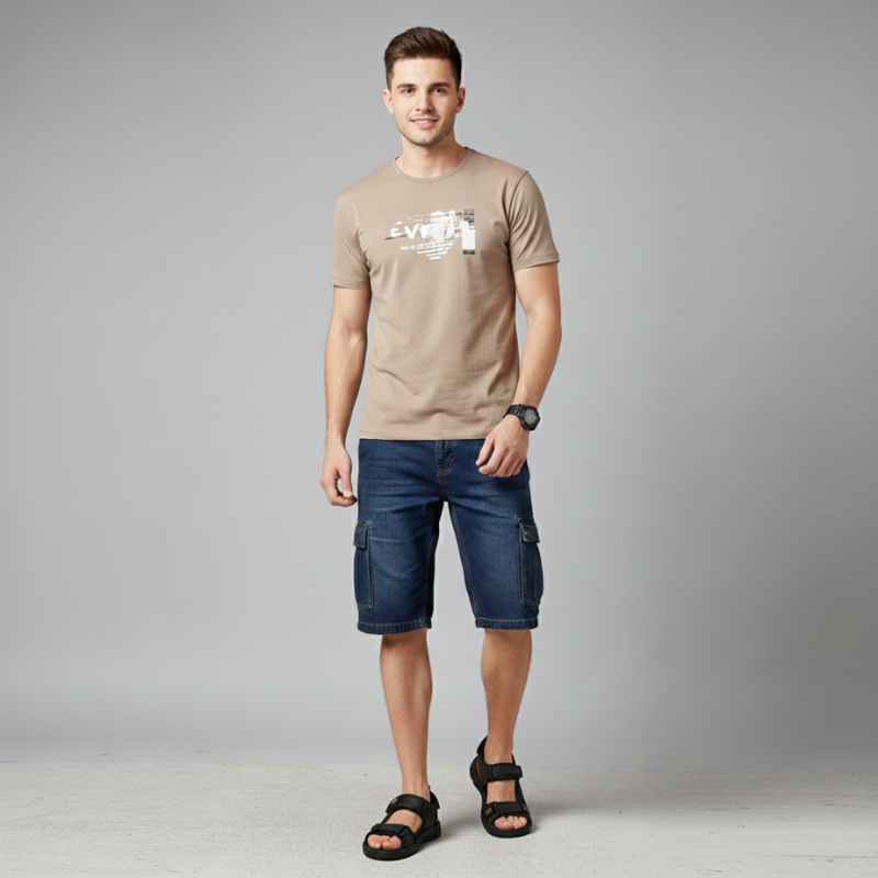 Male model wearing brown sandals styled with a navy t-shirt and denim shorts.