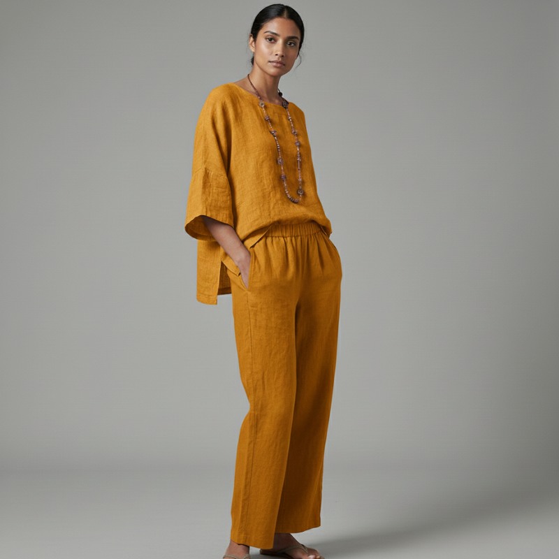 Woman wearing a mustard yellow outfit against a gray background