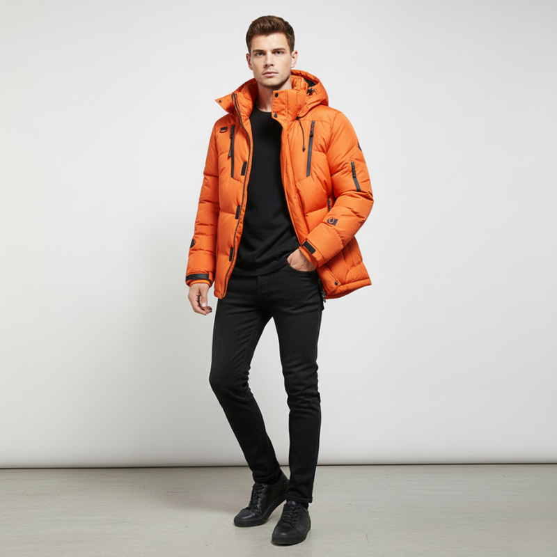 Man wearing an orange puffer jacket against a white background