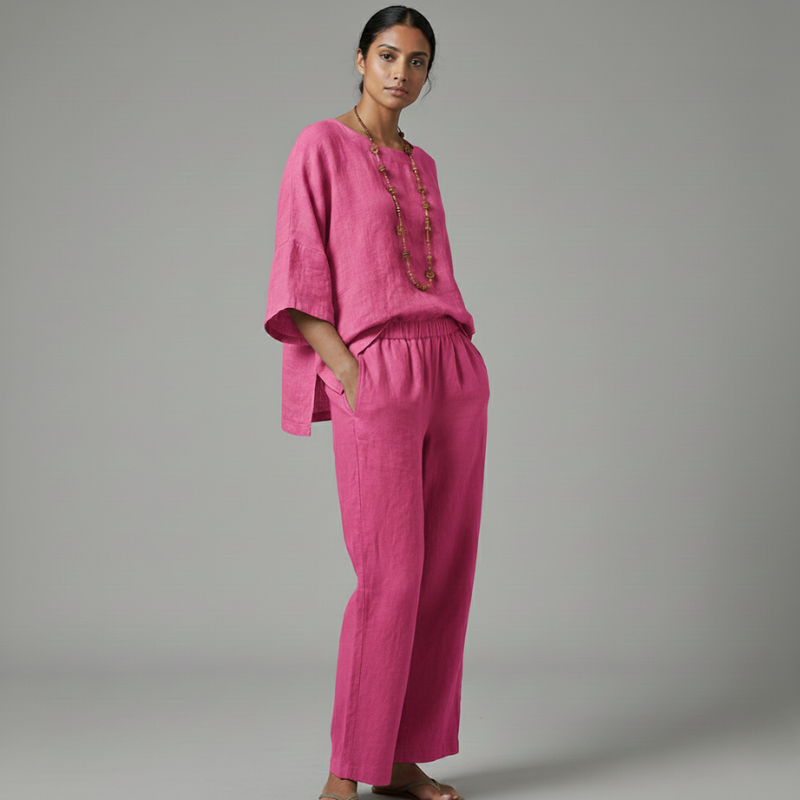 Woman wearing a pink outfit against a gray background