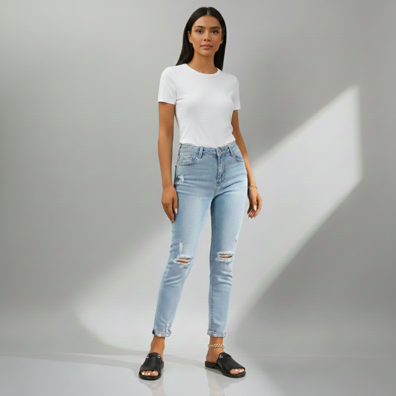 Woman wearing a white t-shirt and light blue jeans on a gray background