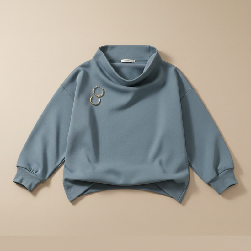 Blue sweatshirt with a brooch on a beige background