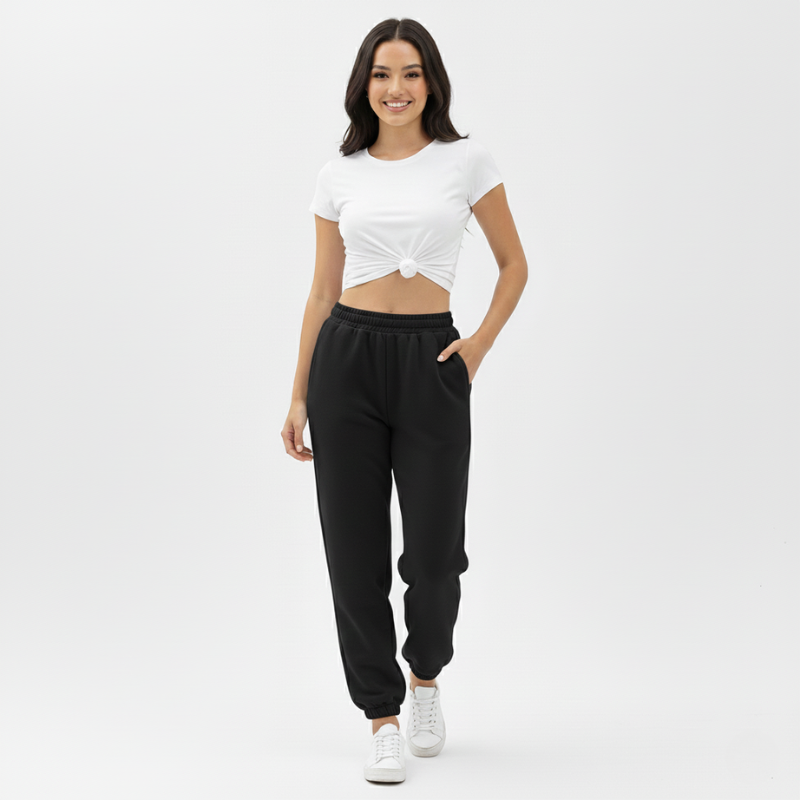 Woman wearing a white top and black pants on a white background