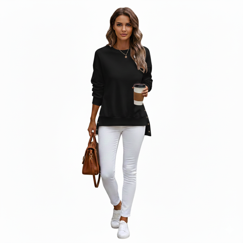 Woman wearing a black long-sleeve top and white pants, holding a coffee cup and brown handbag on a white background