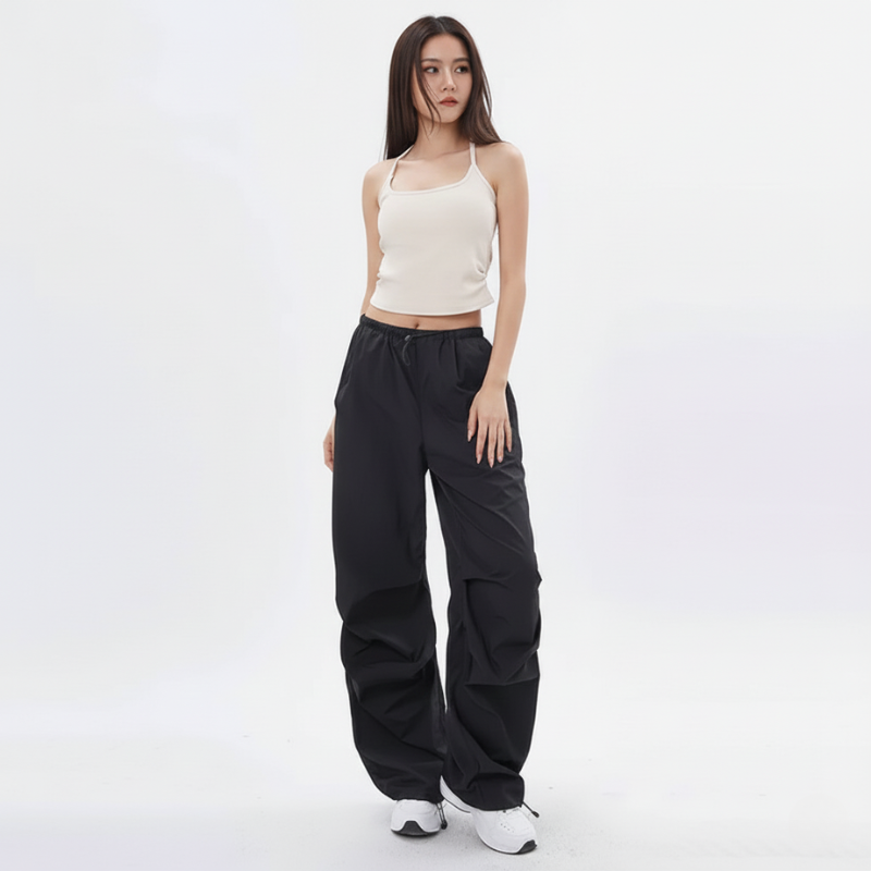 Woman wearing a white top and black pants on a white background