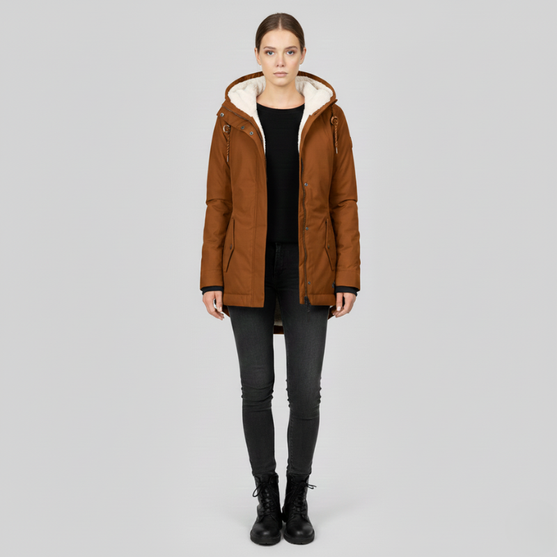 Woman wearing a brown hooded jacket on a gray background