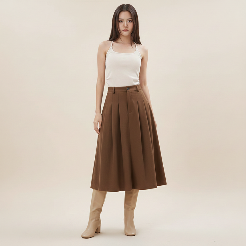 Woman wearing a white top and brown skirt on a beige background