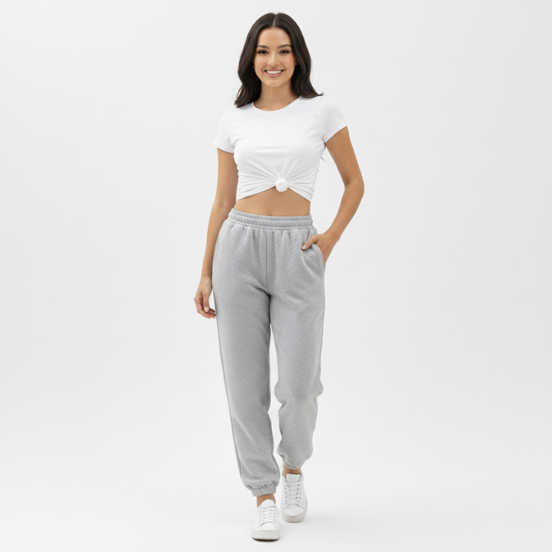 Woman wearing a white top and gray sweatpants on a white background