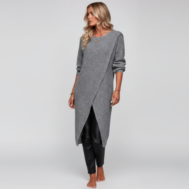 Woman wearing a long gray sweater with a plain background