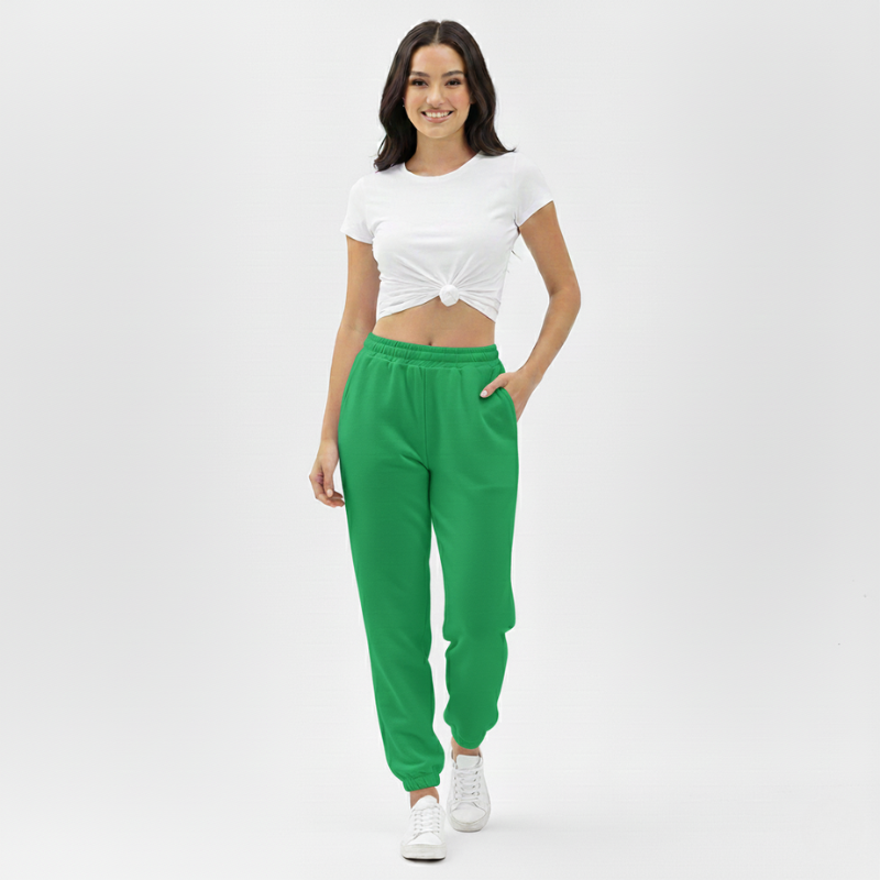 Woman wearing a white top and green pants on a white background