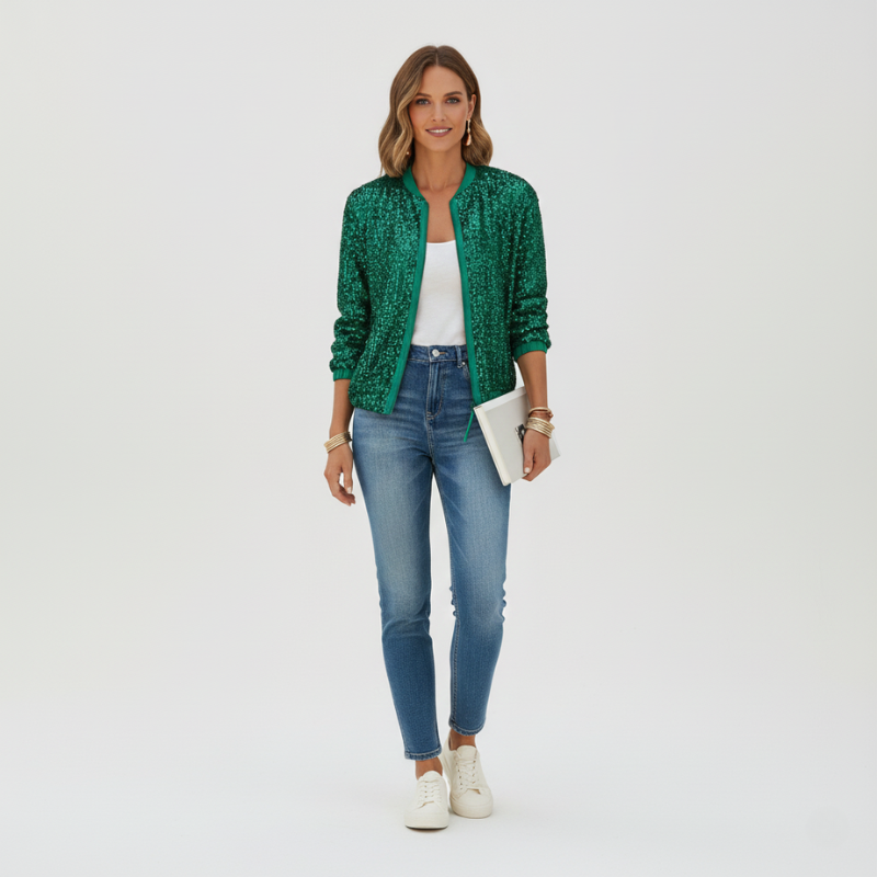 Woman wearing a green patterned jacket, white top, blue jeans, and white sneakers on a white background