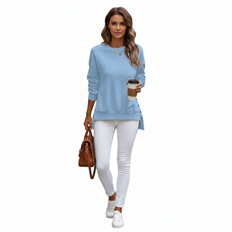 Woman wearing a Dark blue long-sleeve top and white pants, holding a coffee cup and brown handbag on a white background