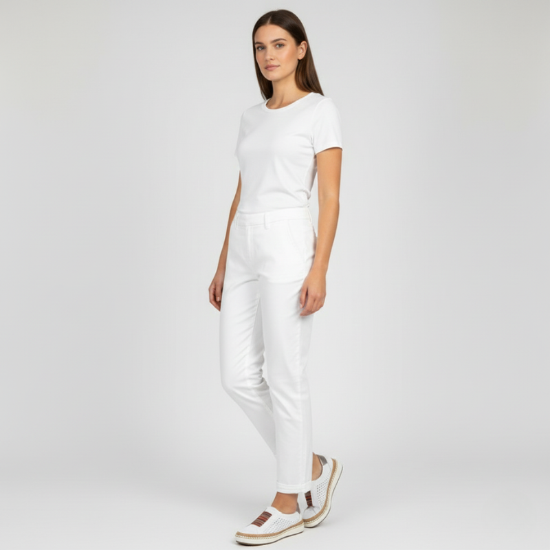 Woman wearing a white outfit on a plain background