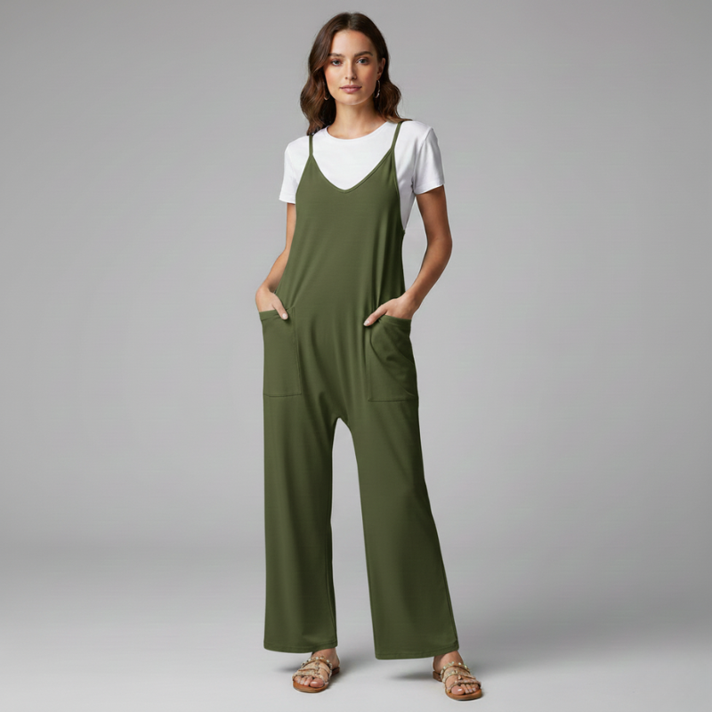 Woman wearing a green jumpsuit over a white shirt on a gray background